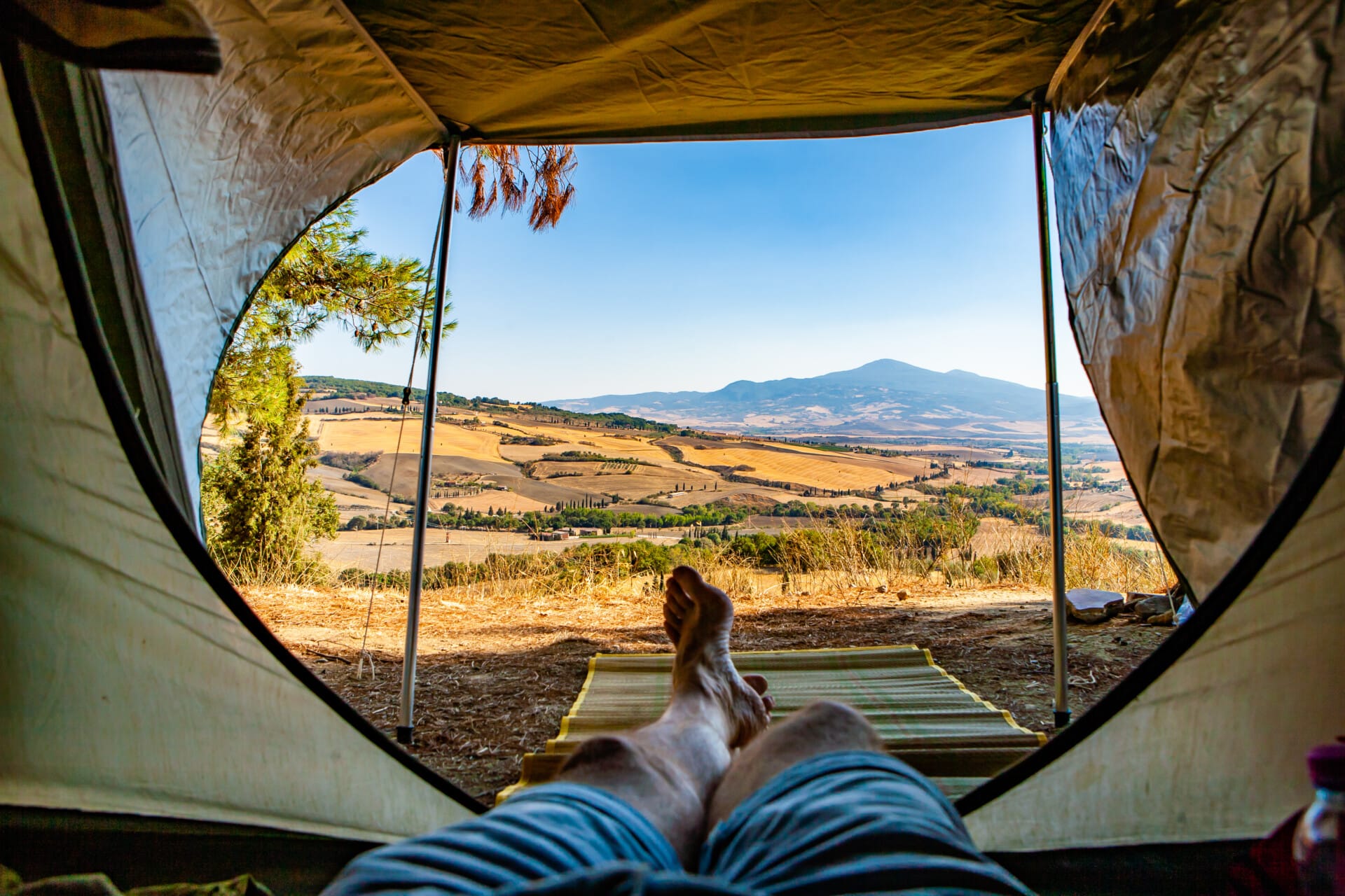 Tranquil camping tents nestled in a serene wilderness setting with stunning mountain views